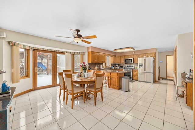 dining area featuring light tile patterned floors and ceiling fan