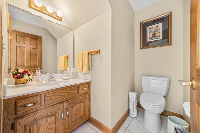 bathroom featuring vaulted ceiling, vanity, toilet, and tile patterned flooring