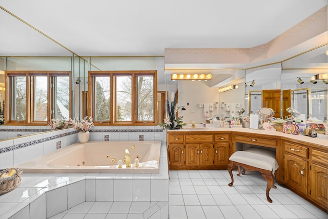 bathroom with tile patterned floors, vanity, and tiled tub