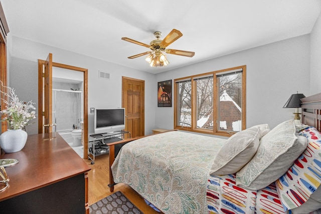 bedroom with ceiling fan, connected bathroom, and light hardwood / wood-style floors