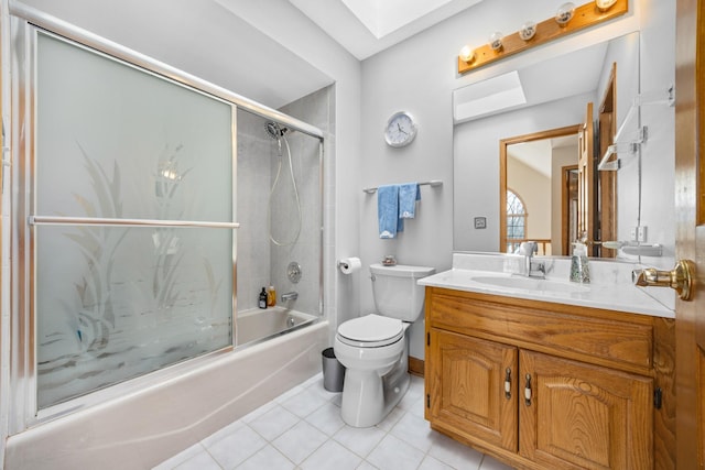 full bathroom with enclosed tub / shower combo, tile patterned flooring, a skylight, vanity, and toilet