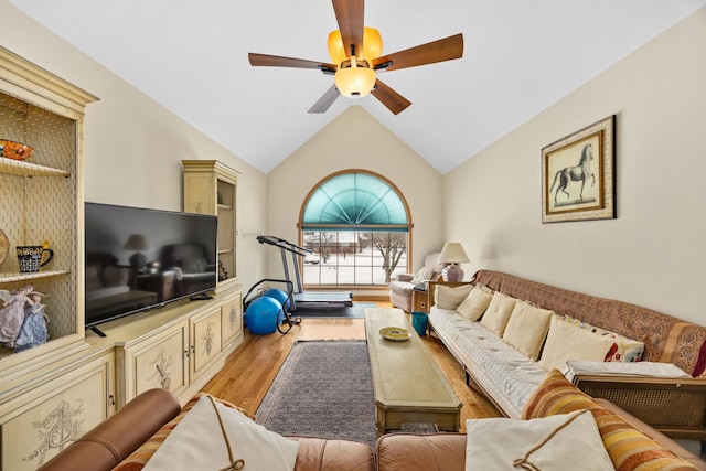 living room featuring vaulted ceiling, ceiling fan, and light hardwood / wood-style flooring