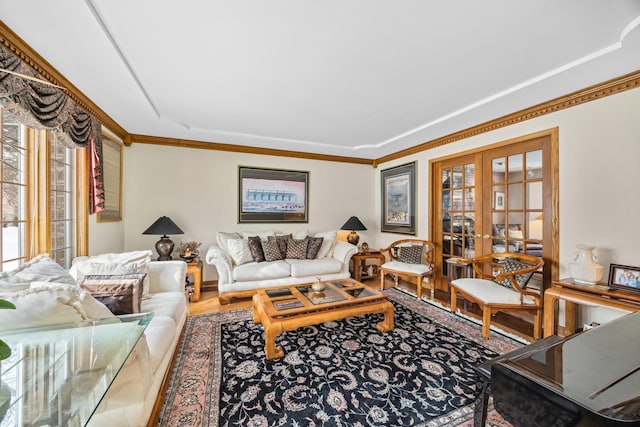 living room with hardwood / wood-style floors, crown molding, and french doors