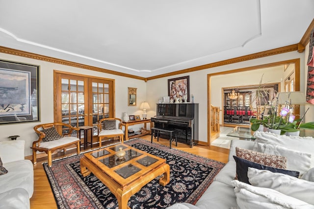 living room with french doors, crown molding, and hardwood / wood-style floors