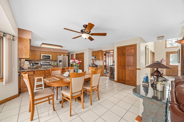 dining room with light tile patterned floors and ceiling fan