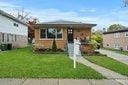 bungalow-style home with a front lawn