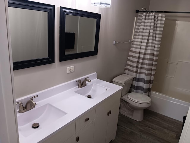 full bathroom with shower / tub combo with curtain, vanity, toilet, and wood-type flooring