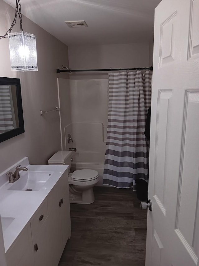 full bathroom featuring shower / bath combination with curtain, vanity, toilet, and hardwood / wood-style floors