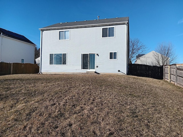 back of house featuring a yard