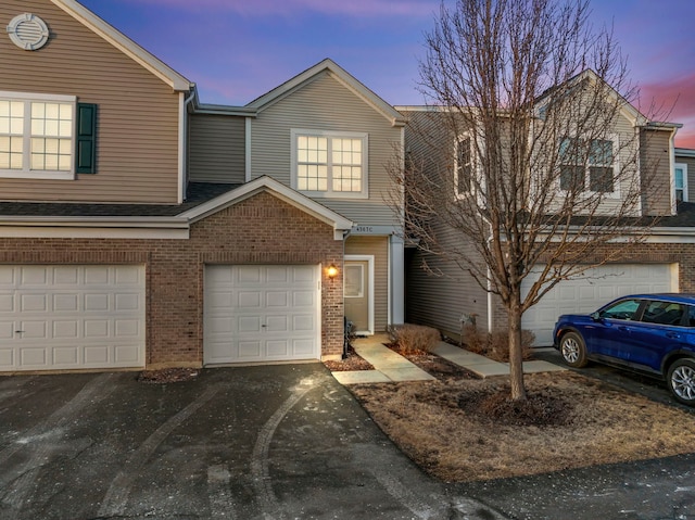 townhome / multi-family property featuring a garage