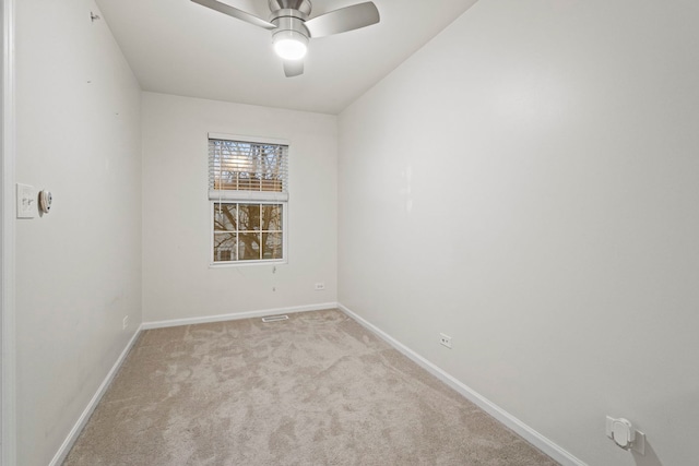 unfurnished room featuring light colored carpet and ceiling fan