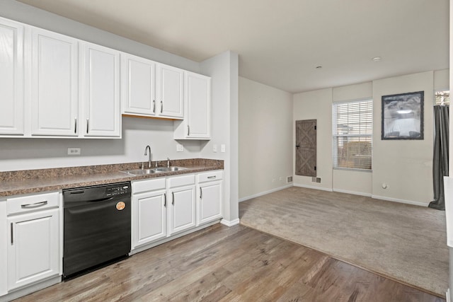 kitchen featuring sink, light hardwood / wood-style flooring, white cabinets, and black dishwasher