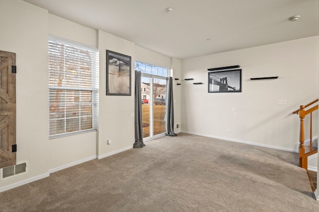 unfurnished room featuring light carpet