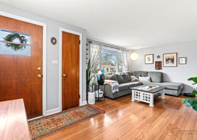 living area featuring baseboards and wood finished floors