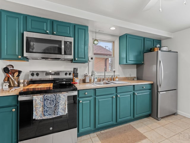 kitchen featuring light tile patterned floors, stainless steel appliances, light countertops, and recessed lighting