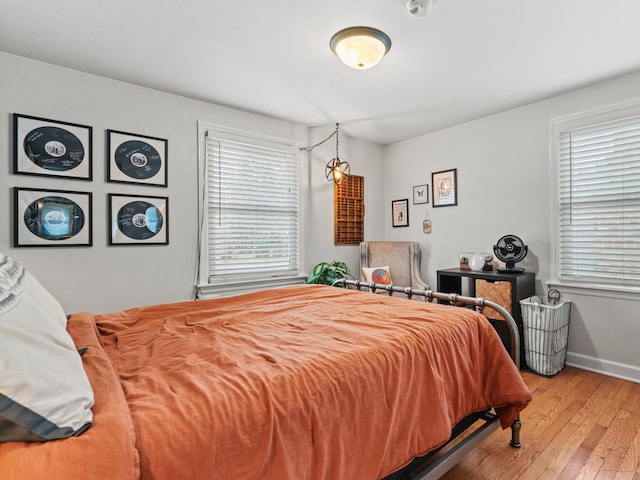 bedroom featuring wood-type flooring and baseboards