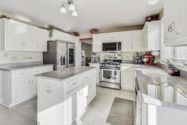 8431 Nielsen Dr, Tinley Park, IL 60487 - kitchen featuring a kitchen island, appliances with stainless steel finishes, white cabinetry, sink, and light tile patterned floors