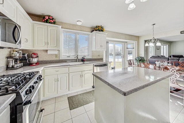 8431 Nielsen Dr, Tinley Park, IL 60487 - kitchen featuring a kitchen island, pendant lighting, white cabinetry, sink, and stainless steel appliances