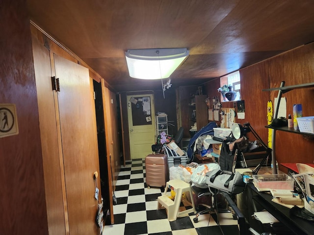 basement featuring wood walls