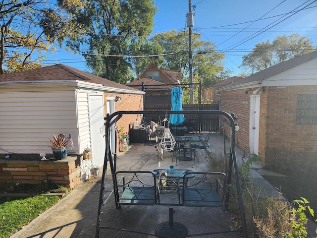 view of patio with an outbuilding