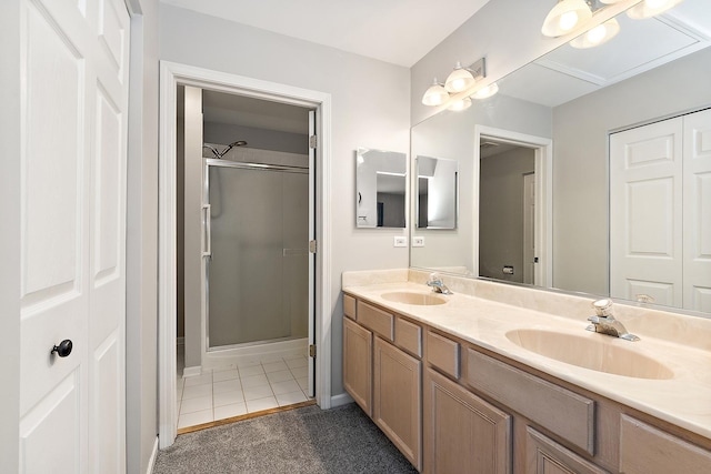 bathroom featuring a shower with door, vanity, and tile patterned floors