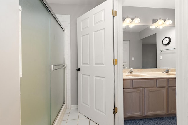 bathroom featuring vanity, an enclosed shower, and tile patterned floors