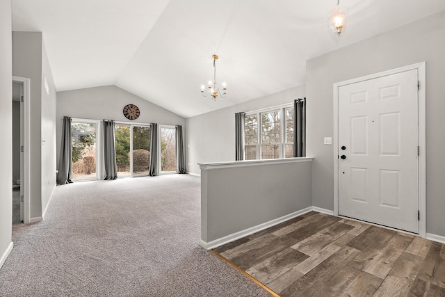 entryway featuring lofted ceiling, dark hardwood / wood-style floors, and a chandelier