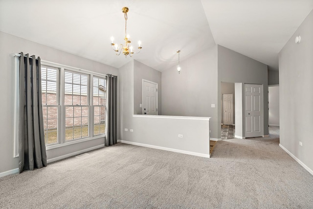 spare room with vaulted ceiling, carpet, and a notable chandelier