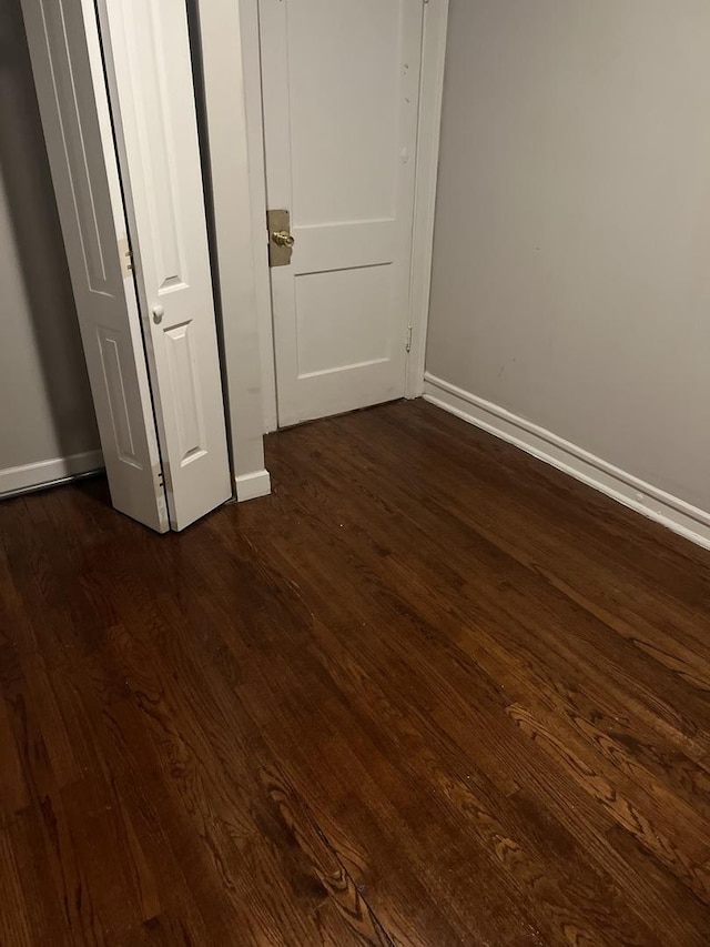 unfurnished bedroom featuring dark hardwood / wood-style flooring