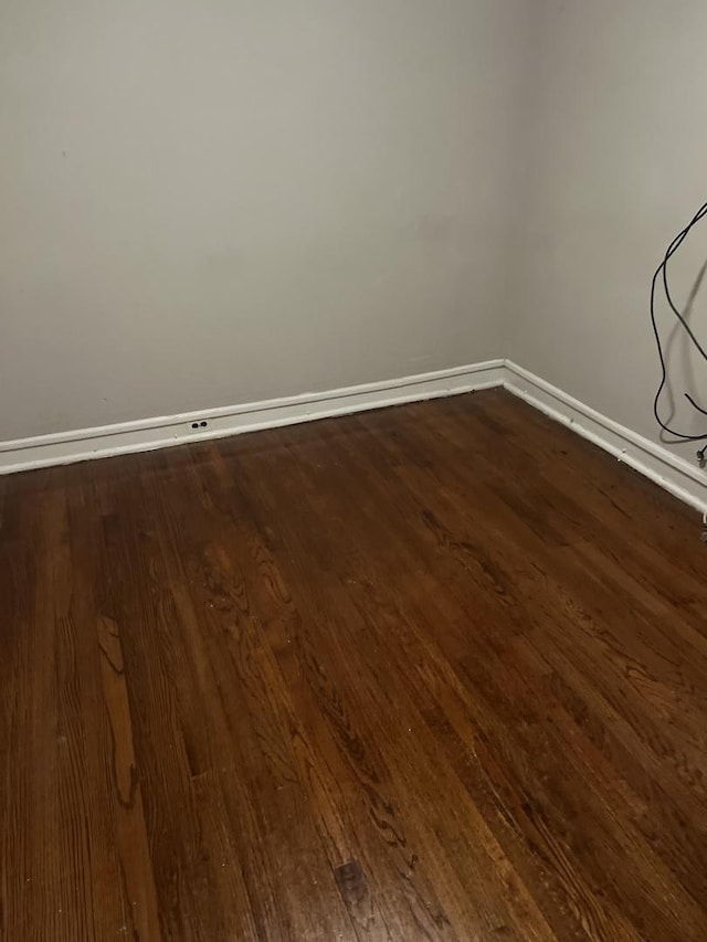 empty room with dark wood-type flooring