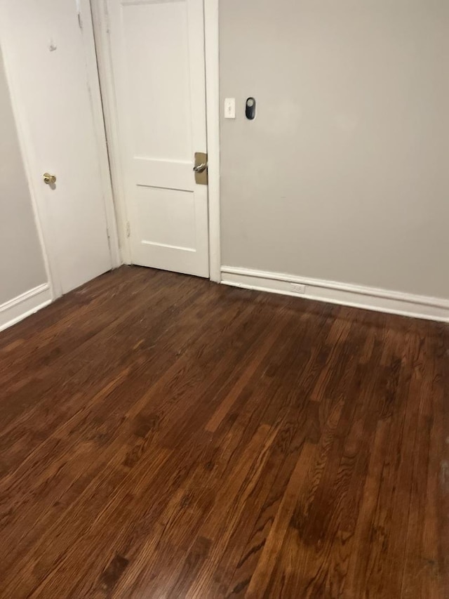 spare room with dark hardwood / wood-style flooring