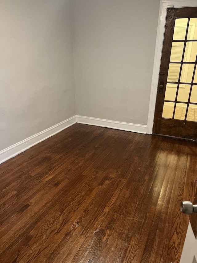 unfurnished room featuring dark hardwood / wood-style floors