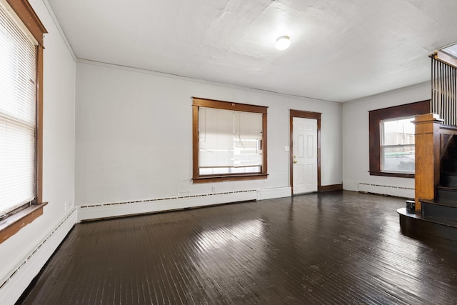 unfurnished living room featuring baseboard heating and dark hardwood / wood-style flooring