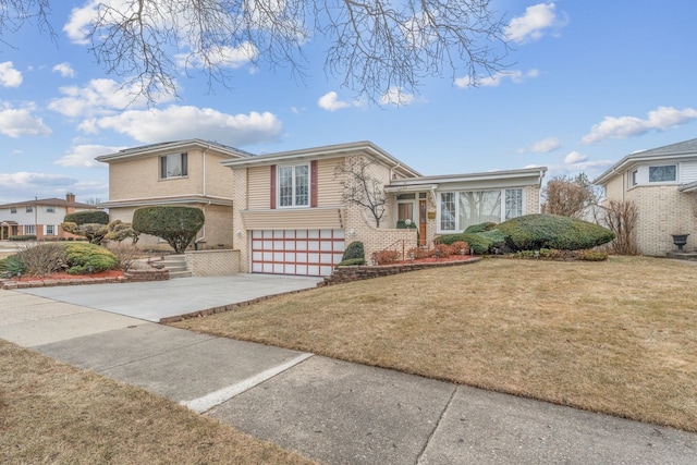 view of front of property featuring a garage and a front lawn