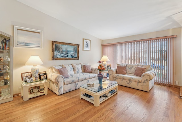 living room featuring lofted ceiling and light wood-type flooring