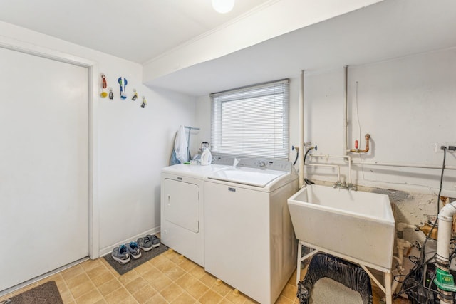 clothes washing area featuring washer and dryer and sink