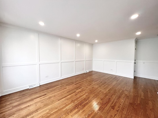 unfurnished room featuring ornamental molding and hardwood / wood-style floors