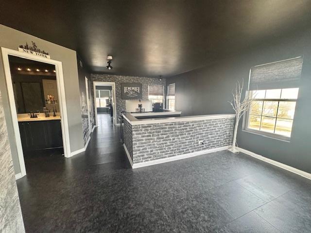 interior space with brick wall and sink