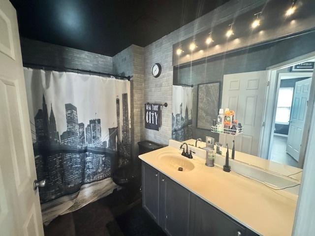 bathroom featuring vanity and curtained shower