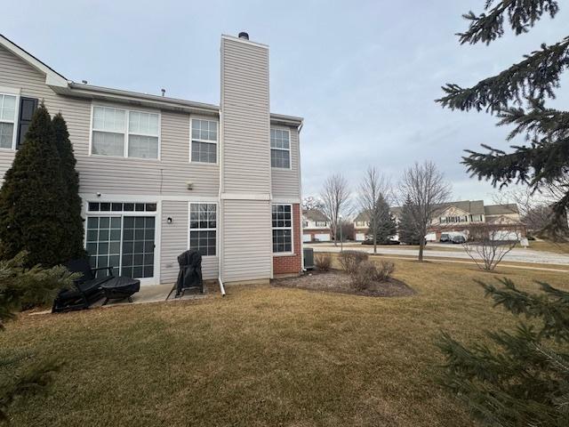 rear view of house with a lawn