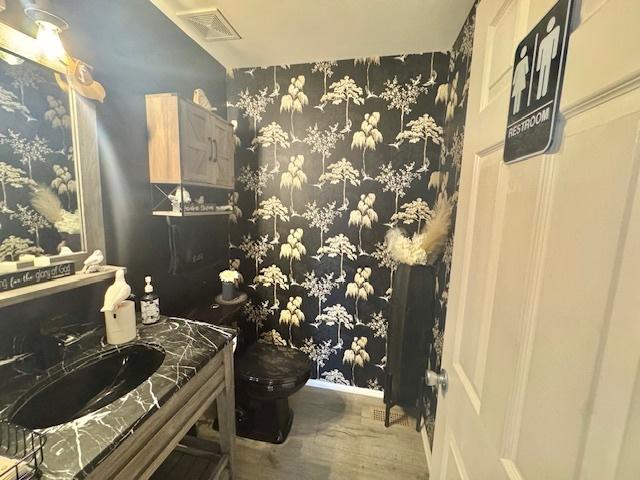 bathroom with vanity, hardwood / wood-style floors, and toilet