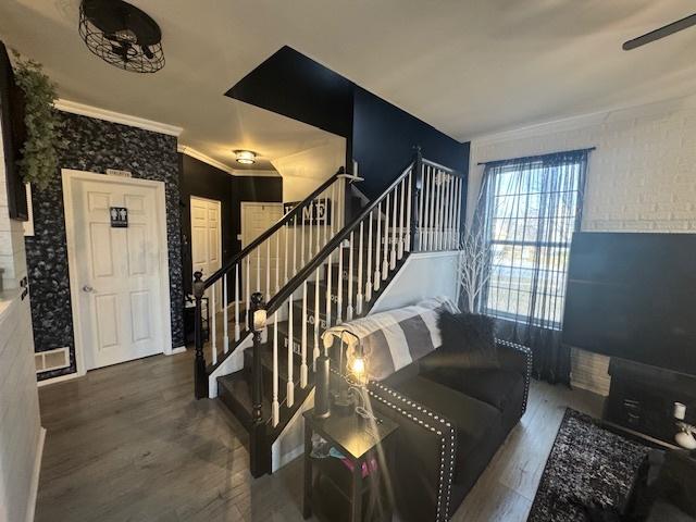 living room featuring ornamental molding and dark hardwood / wood-style floors