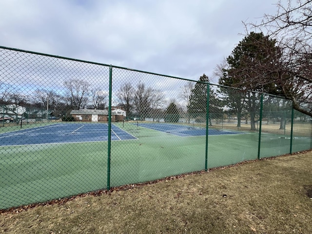 view of sport court featuring fence