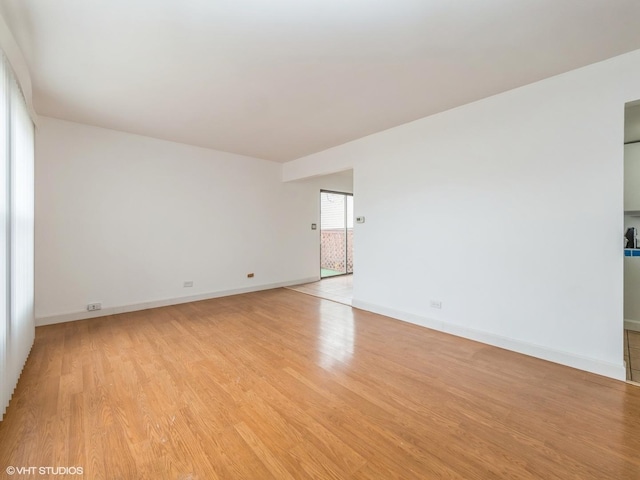 spare room with light hardwood / wood-style flooring