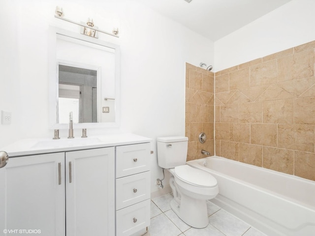 full bathroom featuring tiled shower / bath, vanity, toilet, and tile patterned flooring