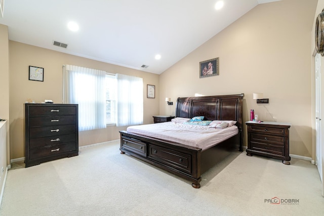 bedroom with lofted ceiling and light colored carpet