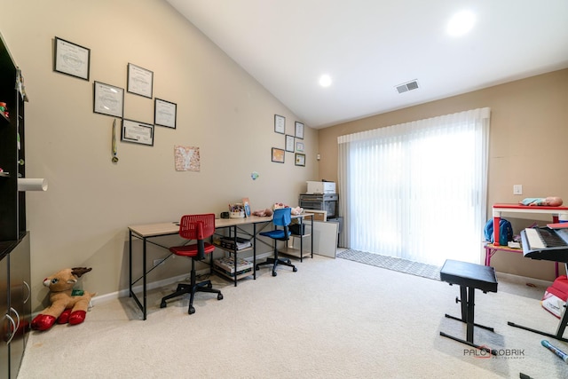 carpeted office with lofted ceiling