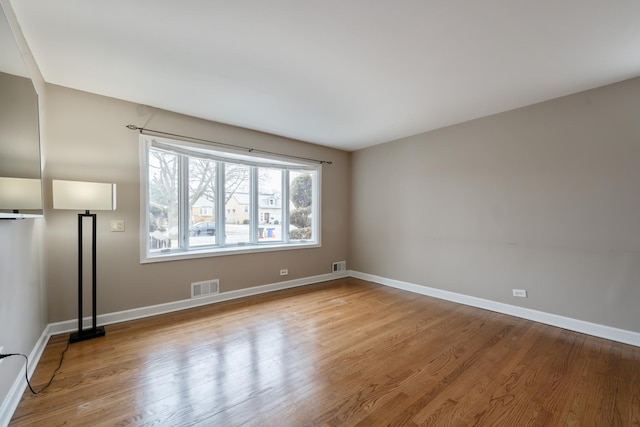 unfurnished room with light hardwood / wood-style flooring