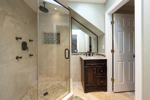 bathroom with vanity, an enclosed shower, and tile patterned floors