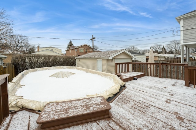 snow covered deck featuring an outbuilding